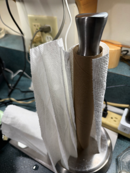 the last paper towel clinging to a roll on a countertop
