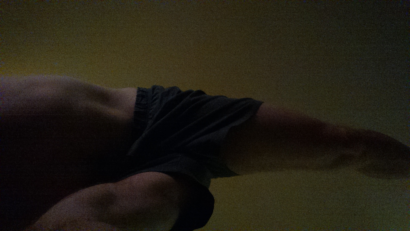 a male body moving into the yoga post warrior 3 as seen from below
